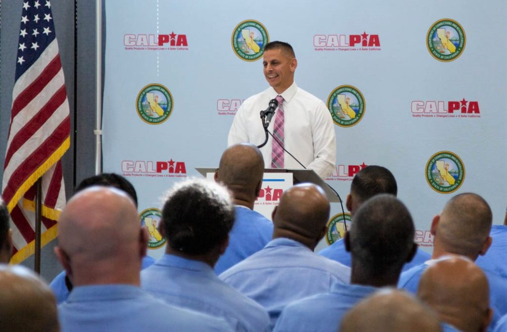 Folsom State Prison (FSP) CALPIA graduation with speaker at a lectern.