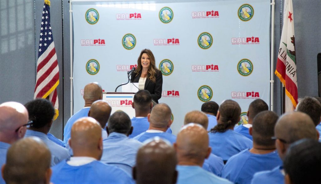 The Folsom State Prison warden speaks to a graduating CALPIA group.
