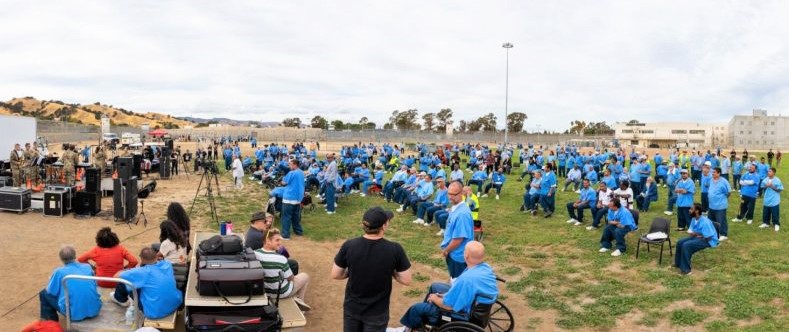 California Medical Facility (CMF) Prison Palooza with incarcerated audience and participants in the yard.
