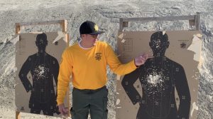 Preston Vogt pointing out marks in a target at COR