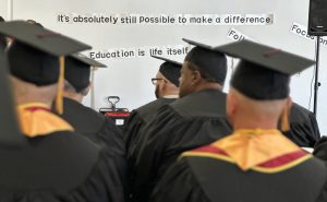 RJD graduates sit in a ceremony to receive their associate degrees.