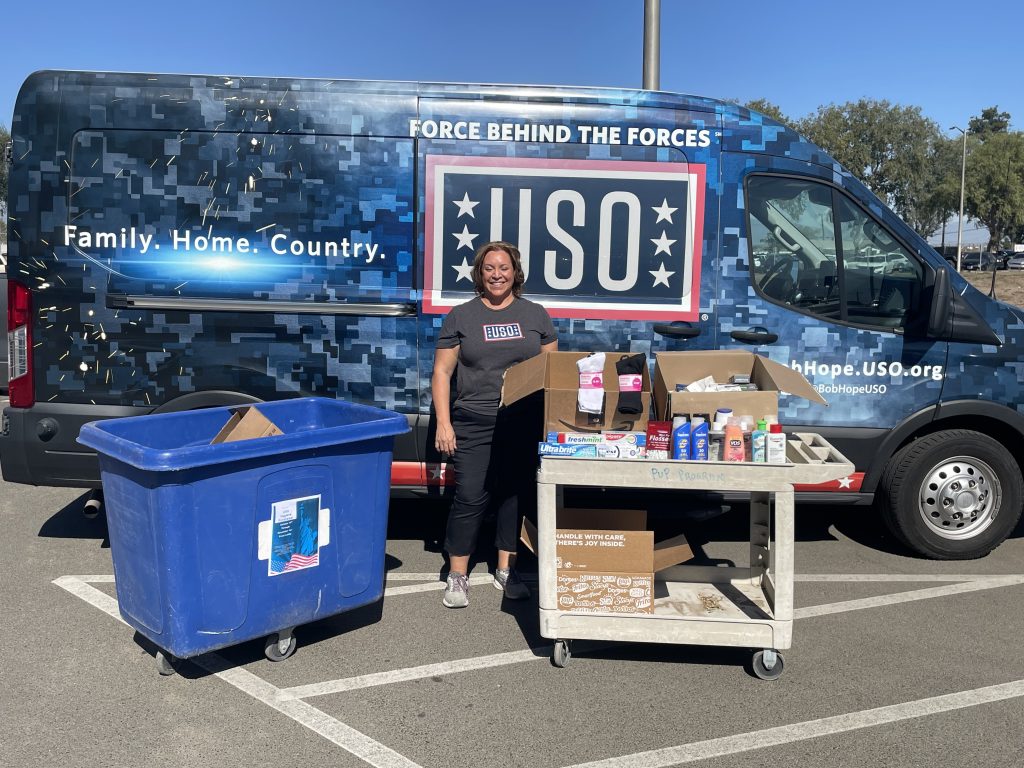 USO van and a woman with donated hygiene items for troops from CIW.