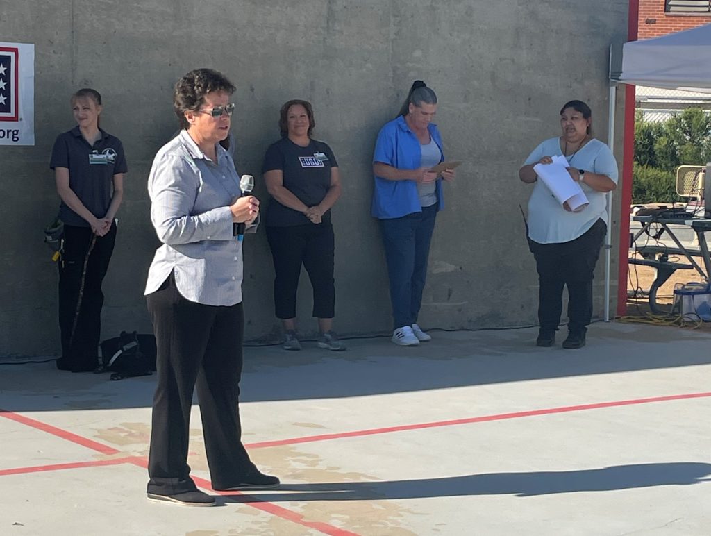 Acting warden at California Institution for Women speaks to a gathering.
