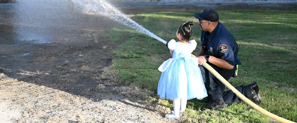 little princess girl shooting fire hose CDCR Halloween