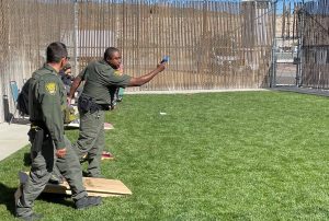 Staff appreciation day at High Desert State Prison (HDSP) shows two officers tossing bean bags.