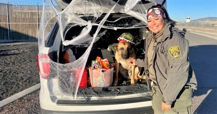 Halloween decorated vehicle with a correctional officer and a K-9.