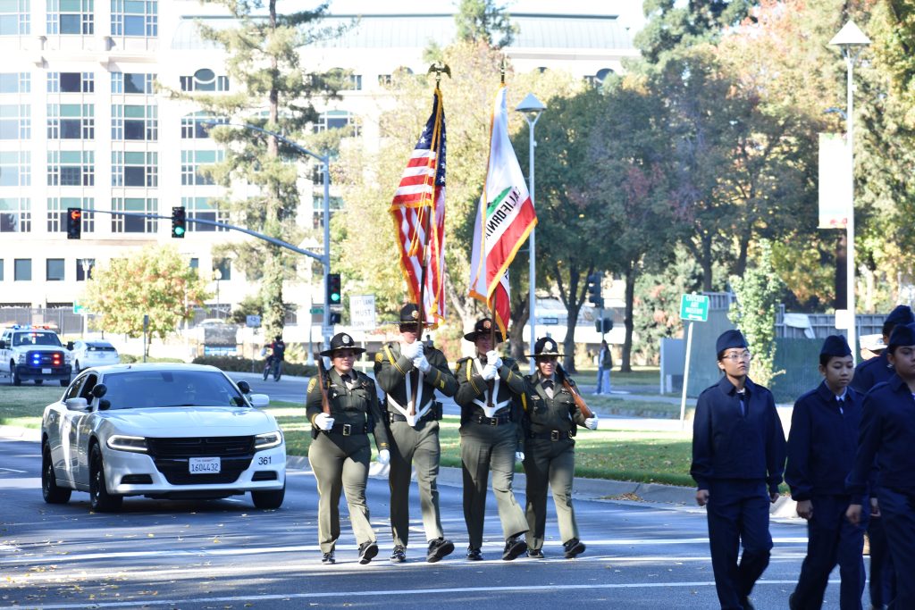 CDCR Honor Guard members carry flags in a Veterans Day Parade in Sacramento at the Capitol. 