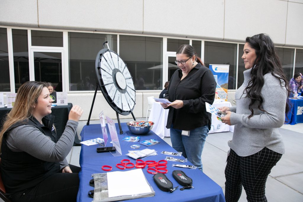 Our Promise event with a table and spin-the-wheel prize game. 