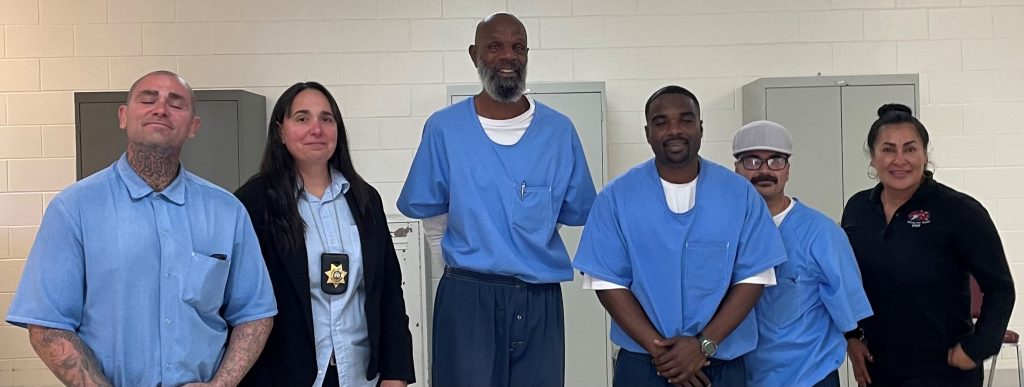Incarcerated people and prison staff pose for a photo at the RJD youth diversion program. 