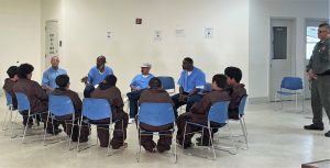 Incarcerated people sitting in a circle with at-risk youth at RJ Donovan Correctional Facility (RJD).