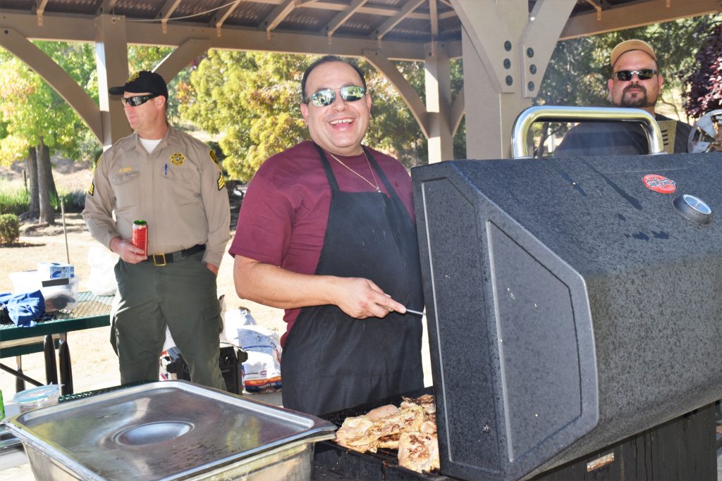 Prison food manager works the grill for the appreciation day.