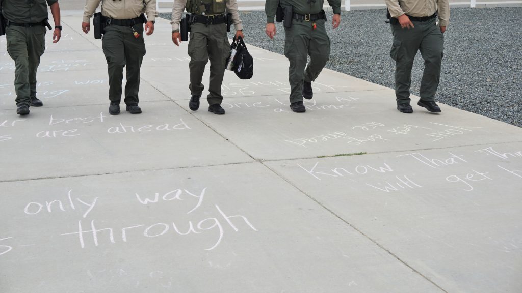 Staff make their way to the next shift with messages written on the pathway.