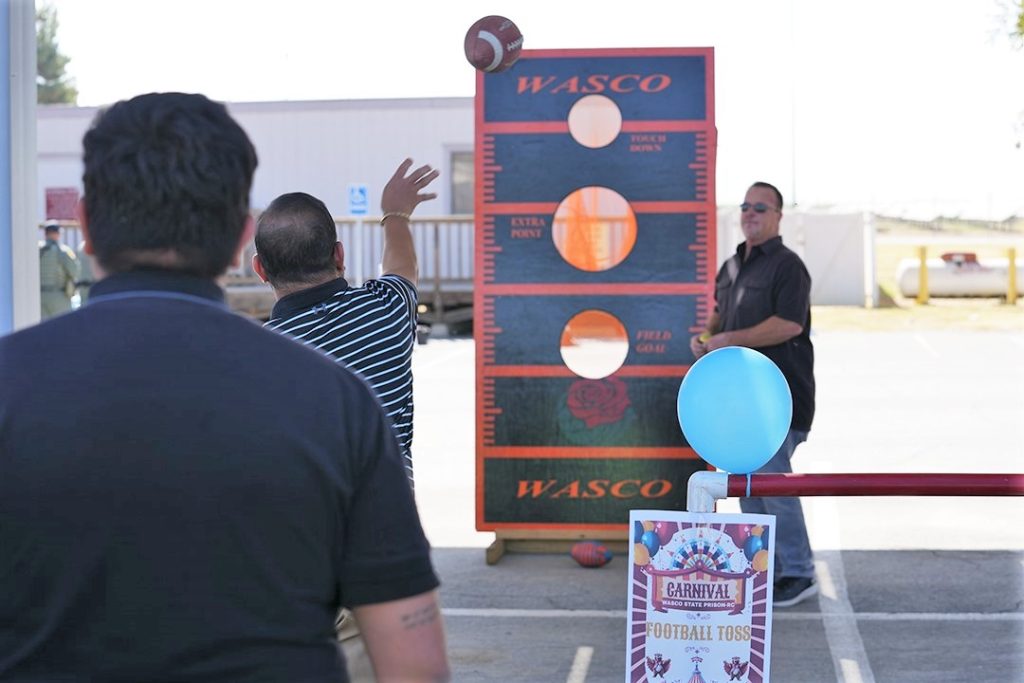 A football toss at a prison staff appreciation festival.