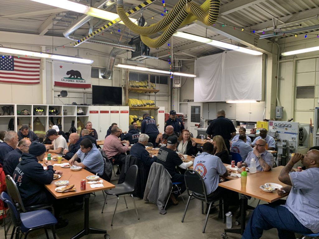 institutional fire department sitting together at CMF pizza feed