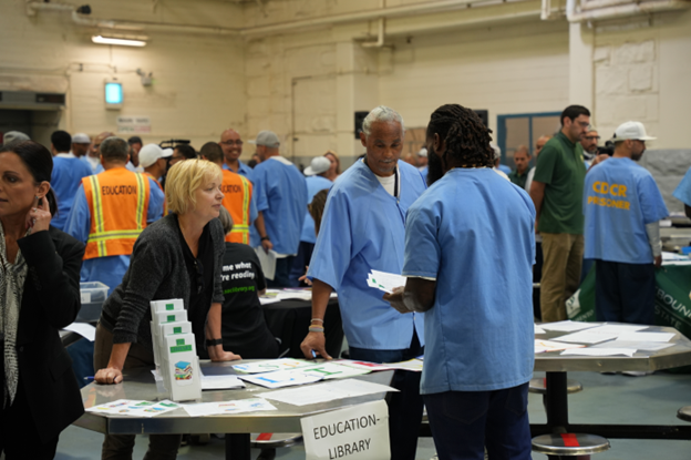 FSP incarcerated speaking with vendors at program fair