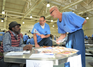 Folsom State Prison resource fair with incarcerated people learning about resources available to them to help transition after release.