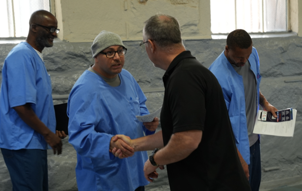 vendor shaking hands with incarcerated at FSP program fair