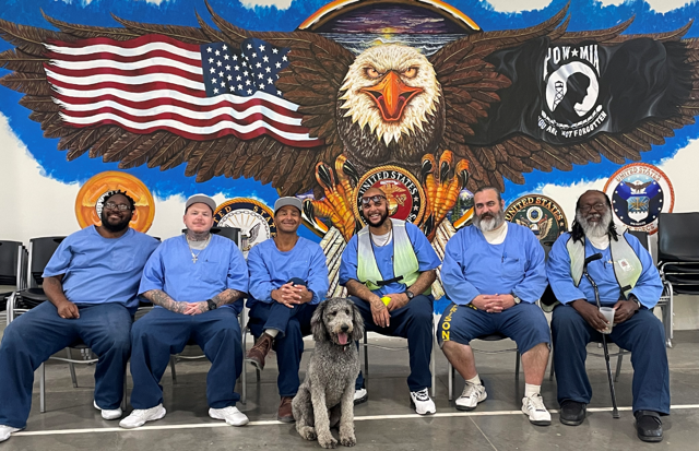 Labradoodle visits with the incarcerated people at HDSP.