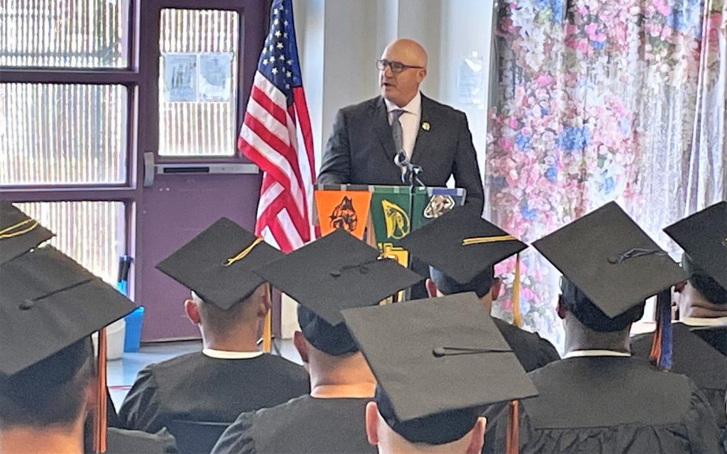 Warden at HDSP speaks to one of four graduations held at the prison.
