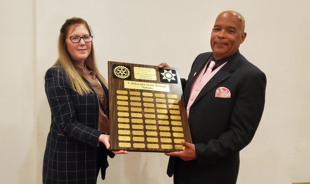 SOL Officer Gregory Meeks and Warden Matteson hold plaque.