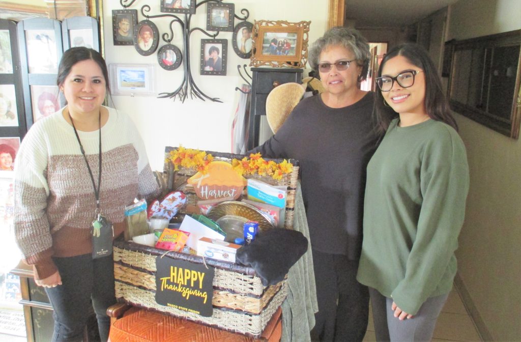Staff members deliver a decorated Thanksgiving basket in Wasco.