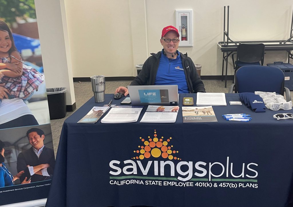 A Savings Plus information booth table at the Our Promise event.