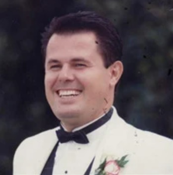 Palok Pepaj wearing a tuxedo and smiling.