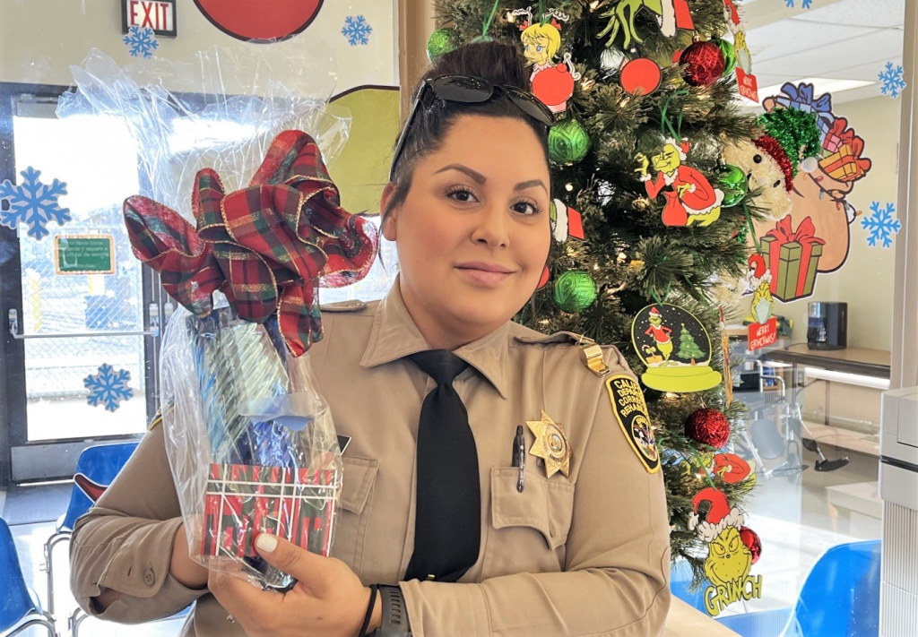 A correctional officer holds a gift.