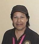 Susana Abarca-Del Toro wearing a hat and lanyard. 