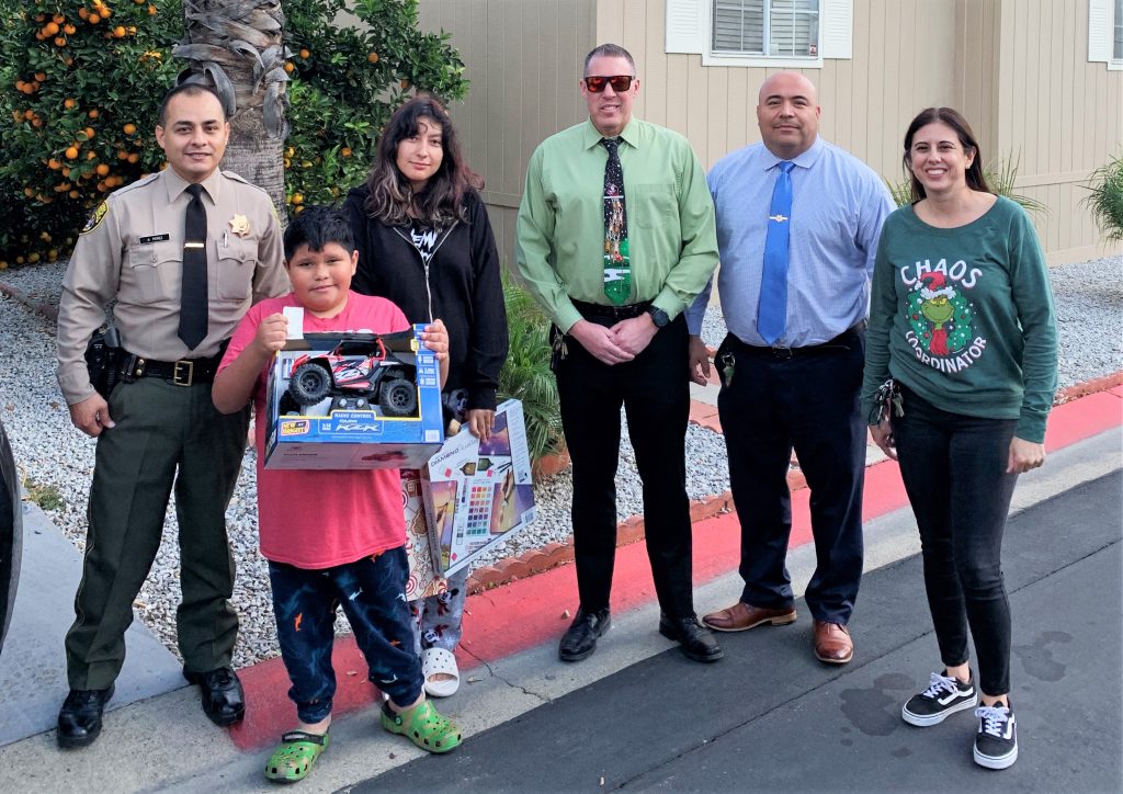 CDCR staff and a family with gifts.