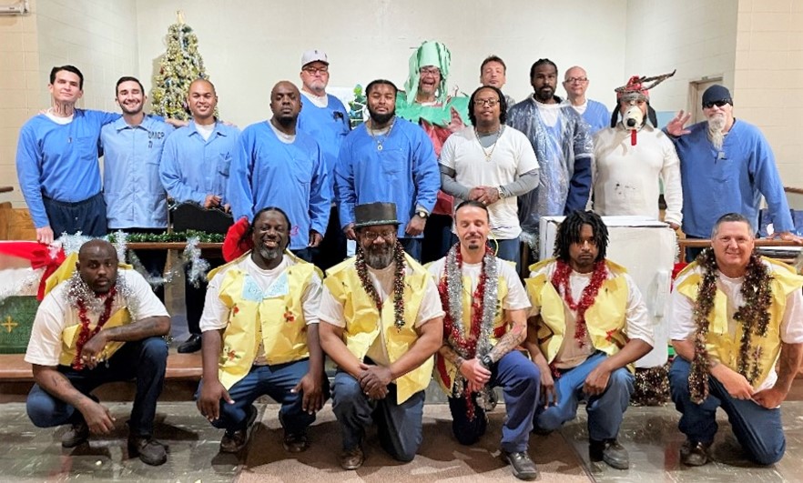 Incarcerated people pose for a photo as part of a staff and peer appreciation holiday theatrical play.