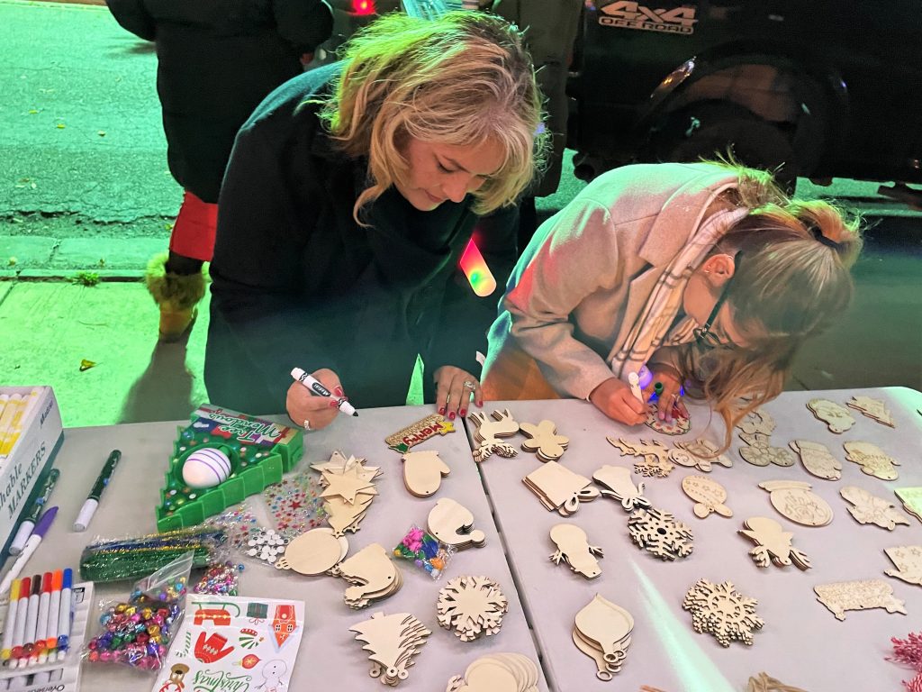 Two people work on arts and crafts.