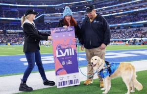 Jade with Super Bowl ticket and two other people standing on a football field.