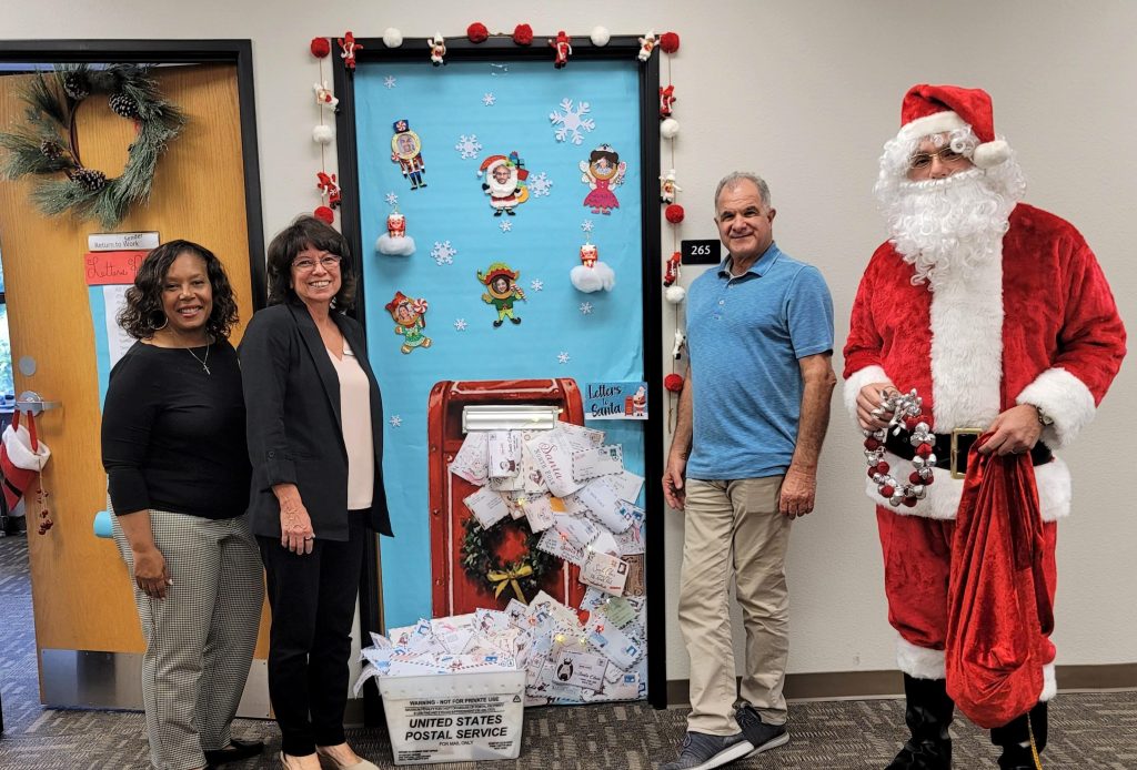 Parole staff with Santa and a decorated door.