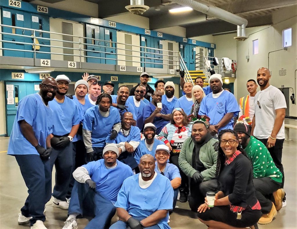 Group photo of incarcerated people and volunteers at California State Prison, Los Angeles County.