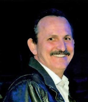 Carl Languerand smiling and looking toward the camera.