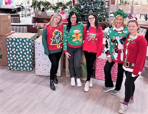 Correctional staff deliver toys to an organization.