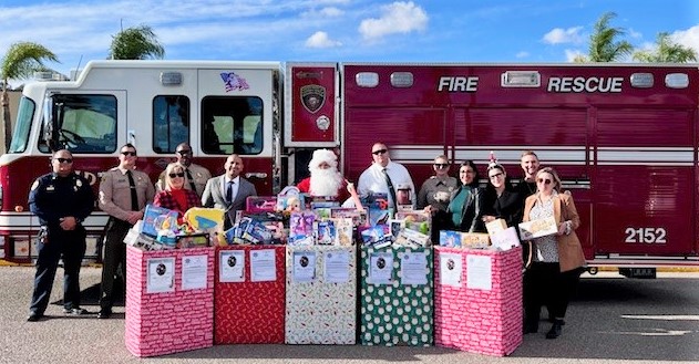 Fire engine with correctional staff, Santa, and boxes of toys tol be donated.