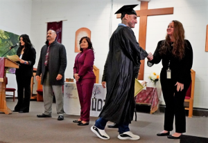 A graduate shakes hands with staff at San Quentin Rehabilitation Center.