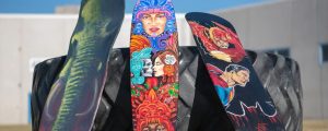 Three painted skateboards