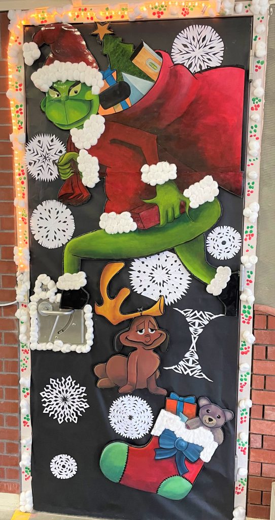 A door with decorations of the Grinch.