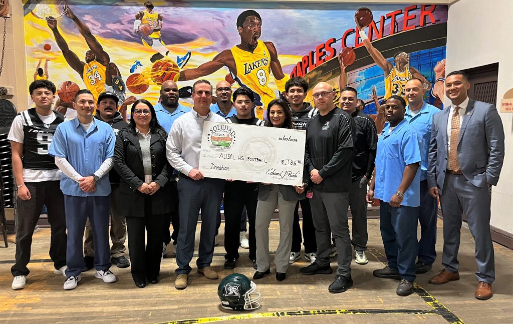 The Correctional Training Facility Fathers Behind Bars program donates over $8,000 to a high school football team.