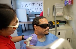 A man wearing protective glasses takes part in a tattoo removal program at Ironwood State Prison.
