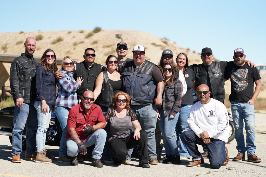A group during the ride pose for a photo with the desert in the background.