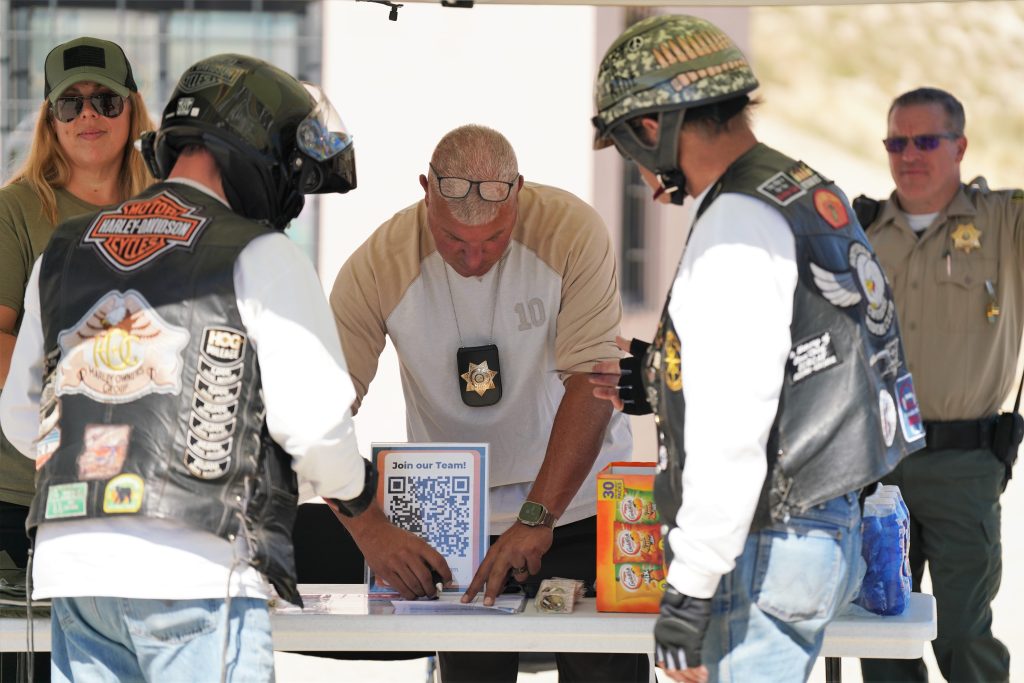 Staff work a booth at the prison during a motorcycle poke run.