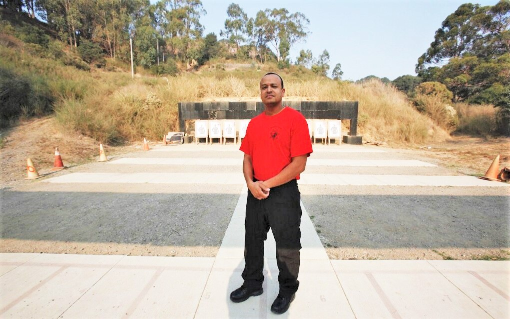 Rangemaster Brian Board, a correctional officer, stands at the shooting range at San Quentin Rehabilitation Center.