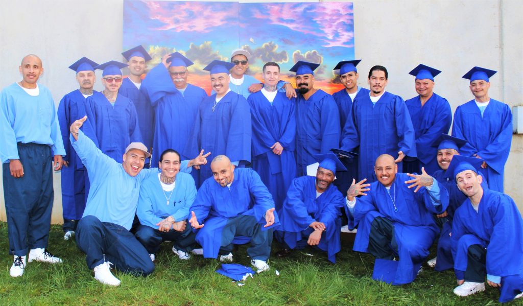 Pelican Bay State Prison Building Resilience program graduates wearing caps and gowns.