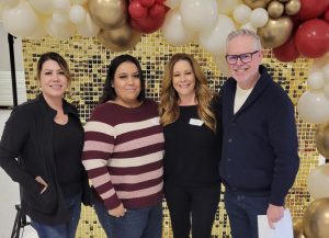 Four Pleasant Valley State Prison ISUDT cross training participants with a backdrop of balloons.