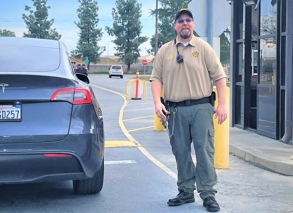 Sergeant Haynes with a car next to him.
