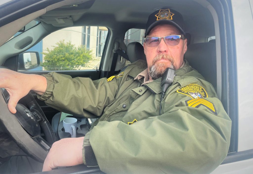 A correctional sergeant sits in a state vehicle at Valley State Prison.